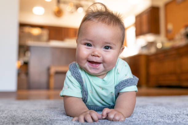 Baby lying on carpet floor | Reinhold Flooring